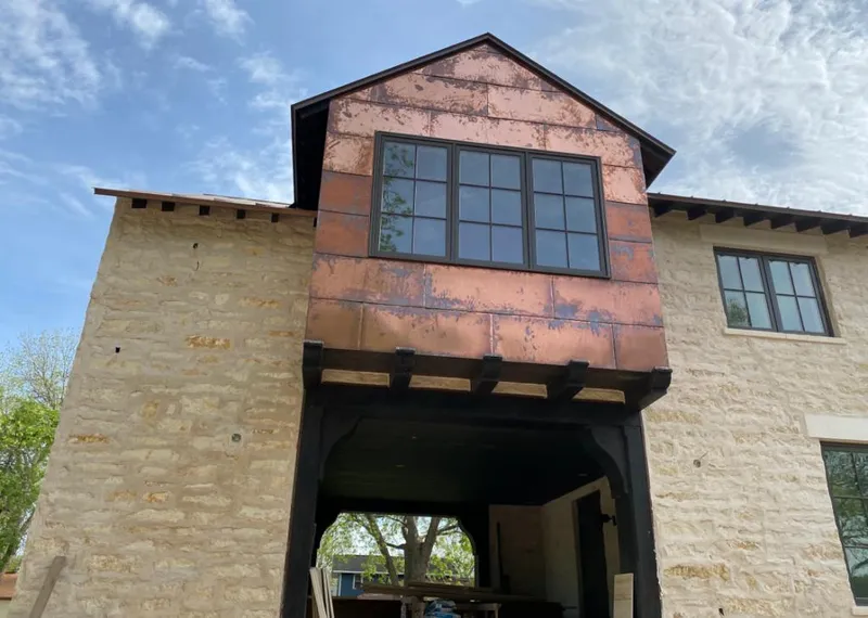 Copper metal panel facade on a stone building for Skylight Installation in Lake Bluff